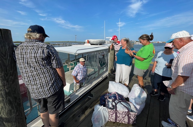 People on a boat dock near a boat.