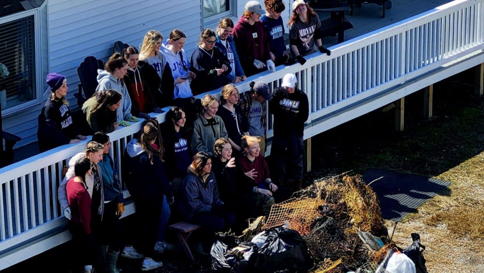 College students and faculty gathered near trash they collected.