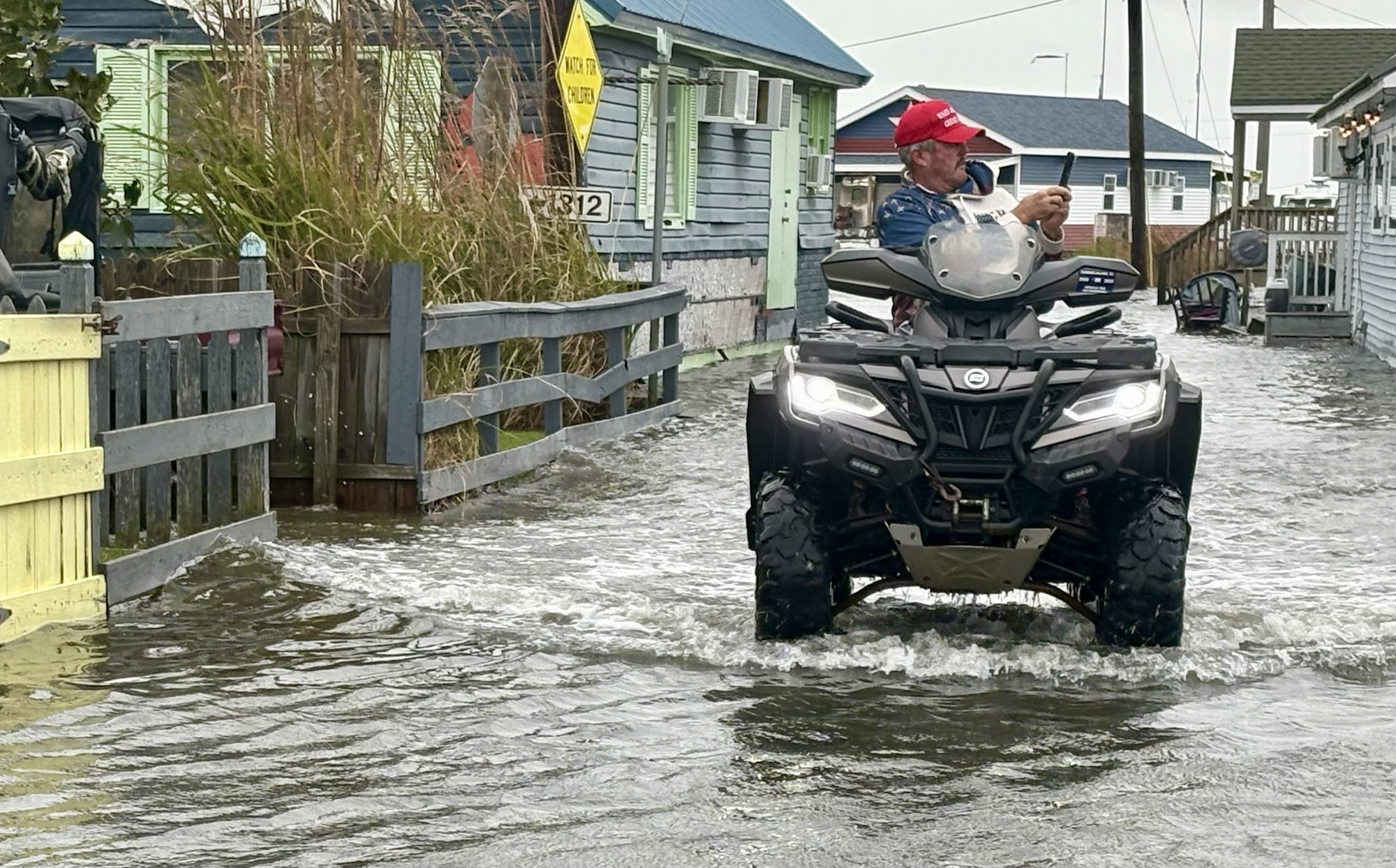 Tommy Eskridge takes photos while riding an ATV.